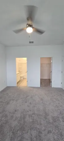 a view of an empty room and a window