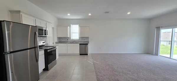 a kitchen with a refrigerator a sink and dishwasher