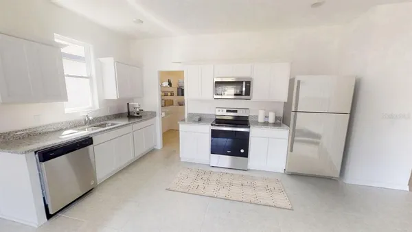 a kitchen with a refrigerator sink and stove