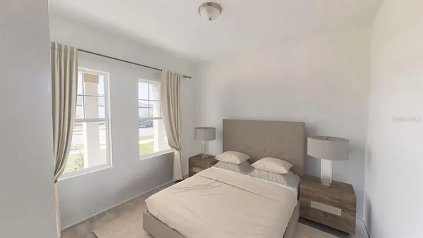 a bedroom with a bed and window