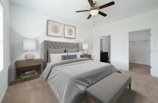 a bedroom with a bed and a chandelier