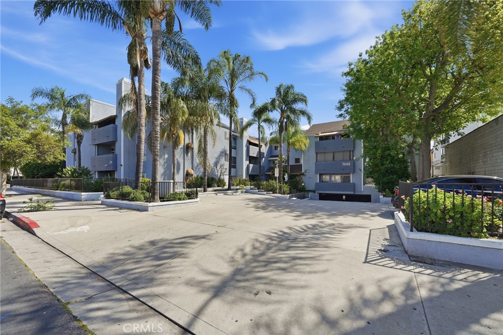 7640 Oso Avenue, Unit 318 Winnetka, CA 91306 - Photo 1 of 43 a row of palm trees in front of a house
