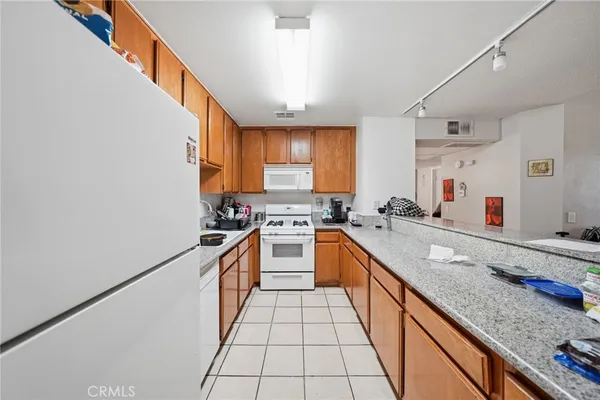 a large kitchen with granite countertop lots of counter top space