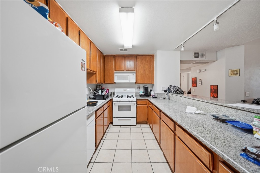 7640 Oso Avenue, Unit 318 Winnetka, CA 91306 - Photo 12 of 43 a large kitchen with granite countertop lots of counter top space