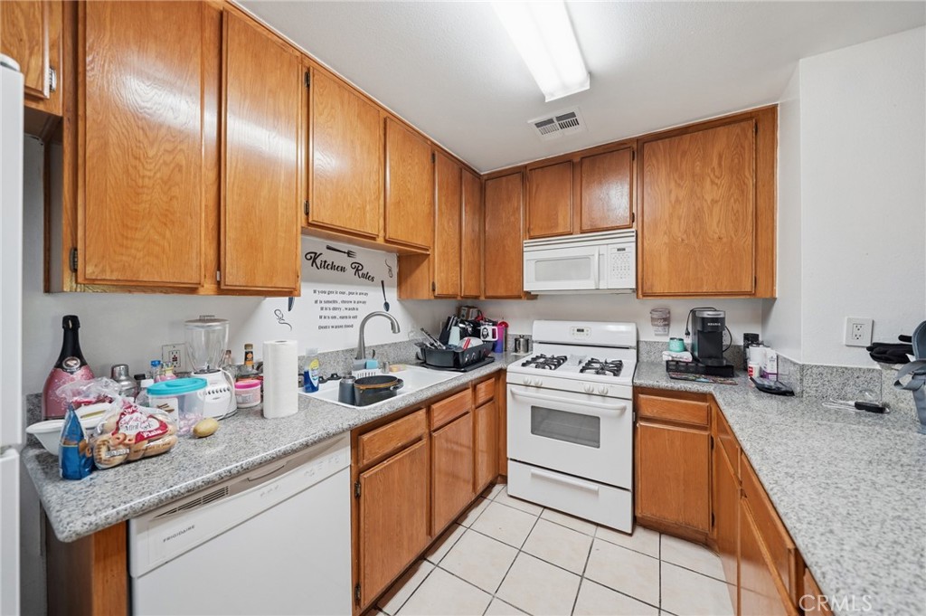 7640 Oso Avenue, Unit 318 Winnetka, CA 91306 - Photo 13 of 43 a kitchen with stainless steel appliances granite countertop a sink stove and cabinets