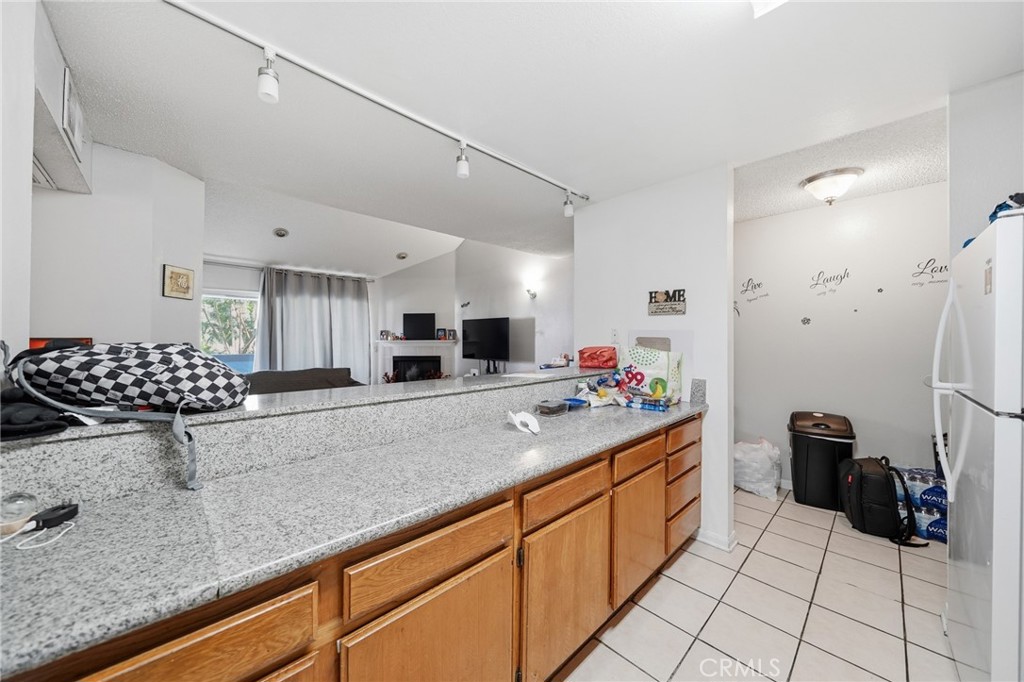 7640 Oso Avenue, Unit 318 Winnetka, CA 91306 - Photo 15 of 43 a kitchen with stainless steel appliances granite countertop a sink stove and refrigerator