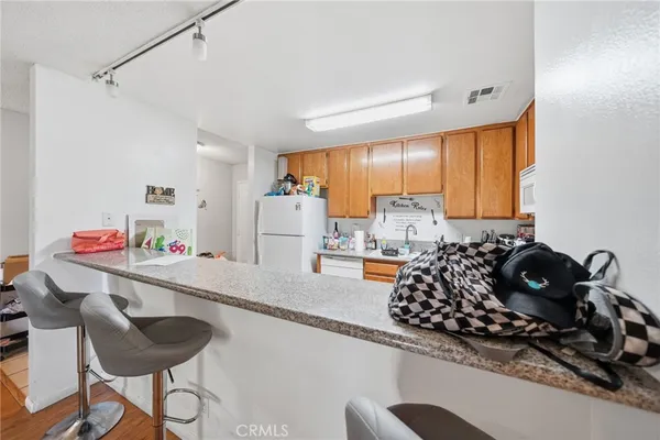 a kitchen with a sink stove and refrigerator