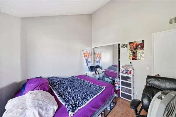 a bedroom with a bed and a closet