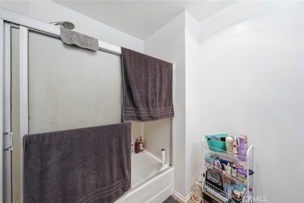 7640 Oso Avenue, Unit 318 Winnetka, CA 91306 - Photo 22 of 43 a bathroom with a bathtub and a shower