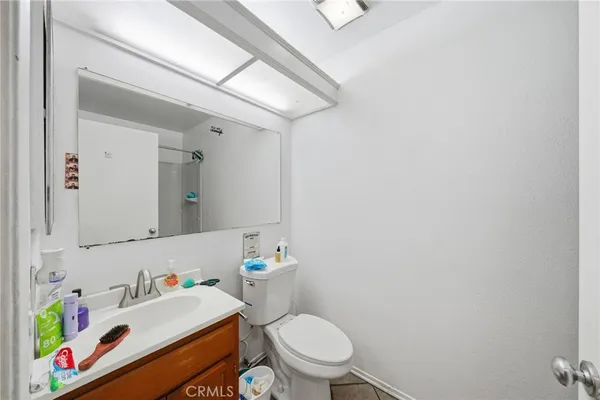 a white toilet sitting next to a bathroom sink
