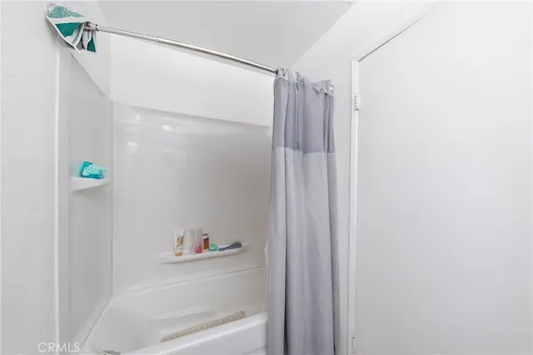 a bathroom with a shower and a bath tub