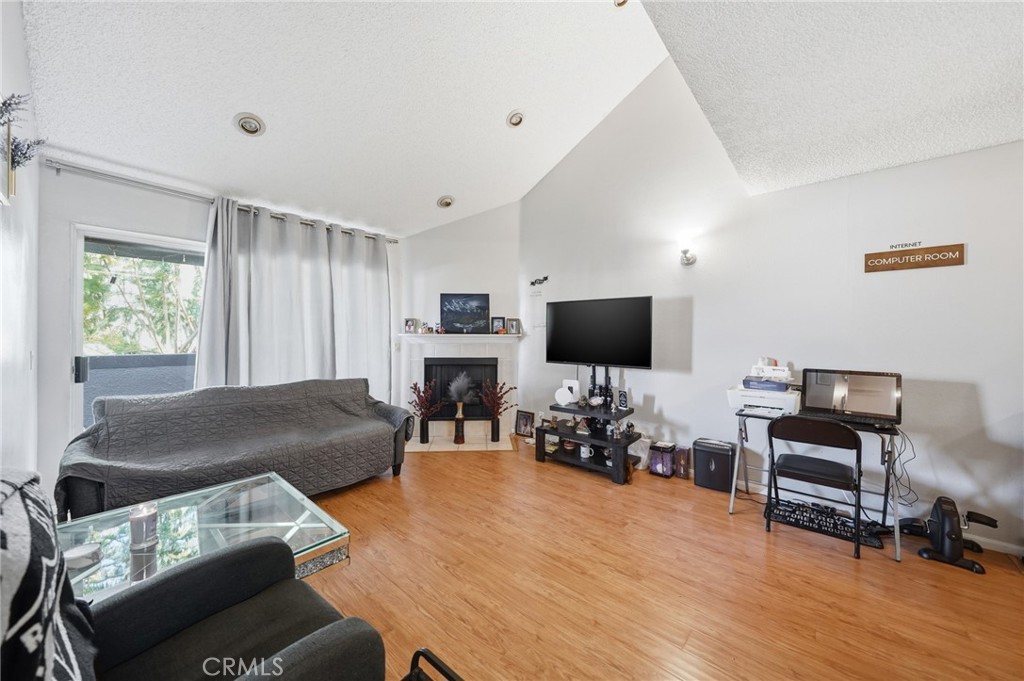 7640 Oso Avenue, Unit 318 Winnetka, CA 91306 - Photo 8 of 43 a living room with furniture and a flat screen tv