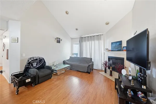 a living room with furniture hard wood floor and a fireplace
