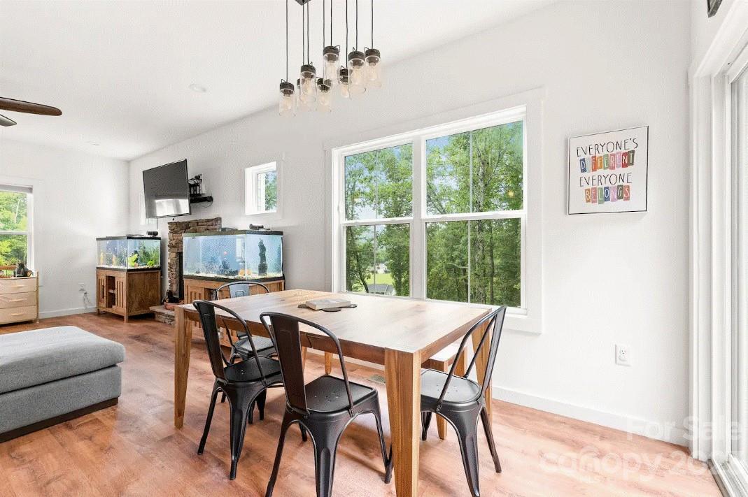 231 Medford Branch Road Candler, NC 28715 - Photo 13 of 28 a view of a dining room with furniture window and outside view