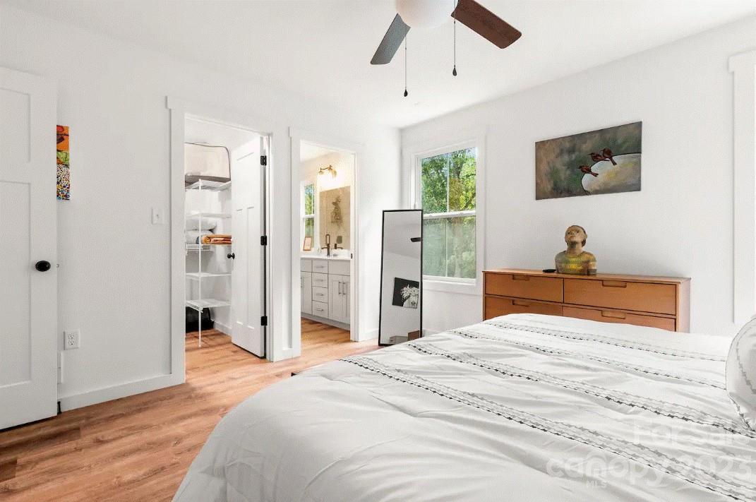 231 Medford Branch Road Candler, NC 28715 - Photo 18 of 28 a bedroom with a bed and a flat screen tv