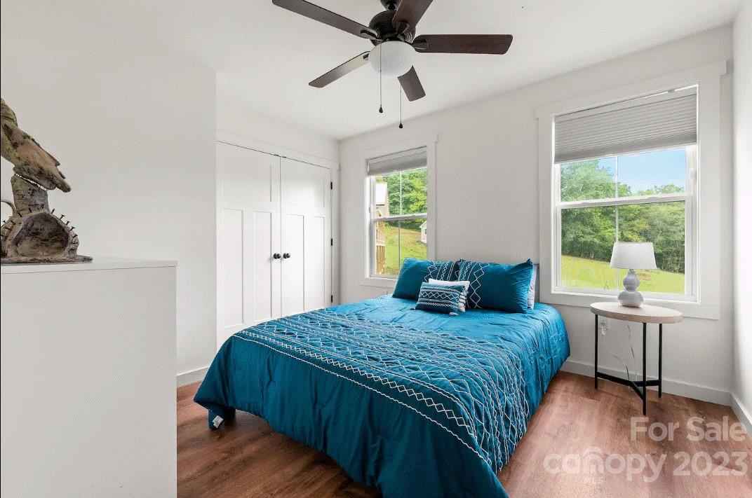 231 Medford Branch Road Candler, NC 28715 - Photo 21 of 28 a bedroom with a bed and a table in it