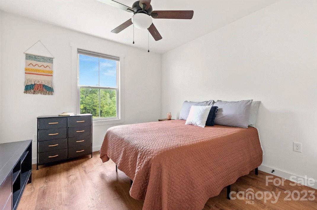 231 Medford Branch Road Candler, NC 28715 - Photo 23 of 28 a bedroom with a bed and a window