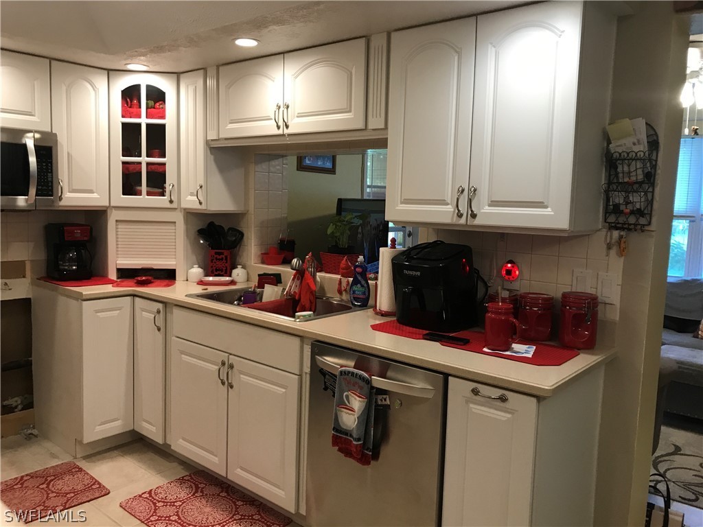 2719 W Road Fort Myers, FL 33905 - Photo 8 of 15 a kitchen with stainless steel appliances granite countertop a sink and cabinets