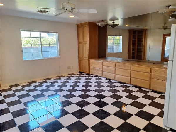a large kitchen with a checkered floor and chandelier