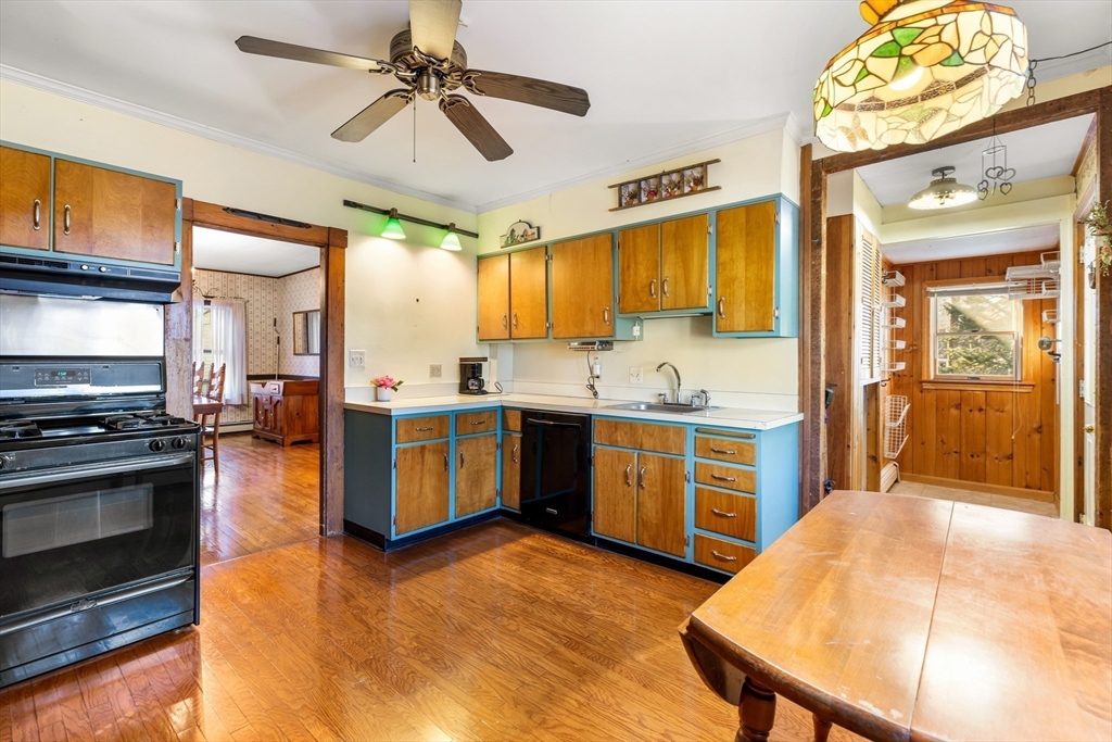142 Bancroft Avenue Reading, MA 01867 - Photo 17 of 30 a kitchen with a stove a sink and a refrigerator