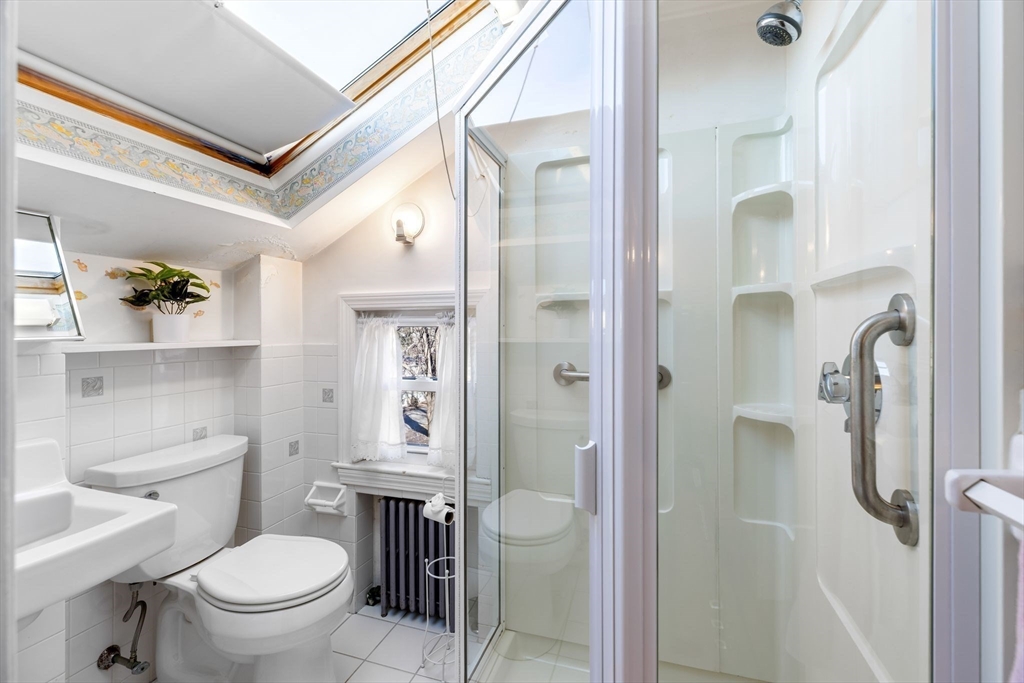 142 Bancroft Avenue Reading, MA 01867 - Photo 23 of 30 a bathroom with a toilet a sink and shower