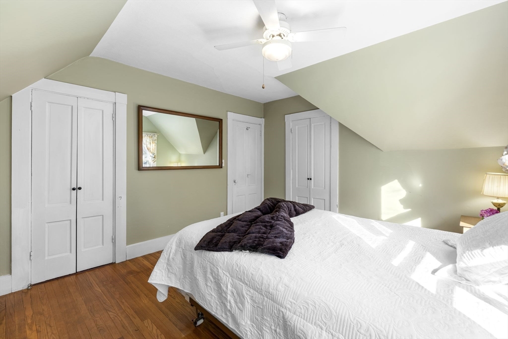 142 Bancroft Avenue Reading, MA 01867 - Photo 25 of 30 a bedroom with a bed and a chandelier