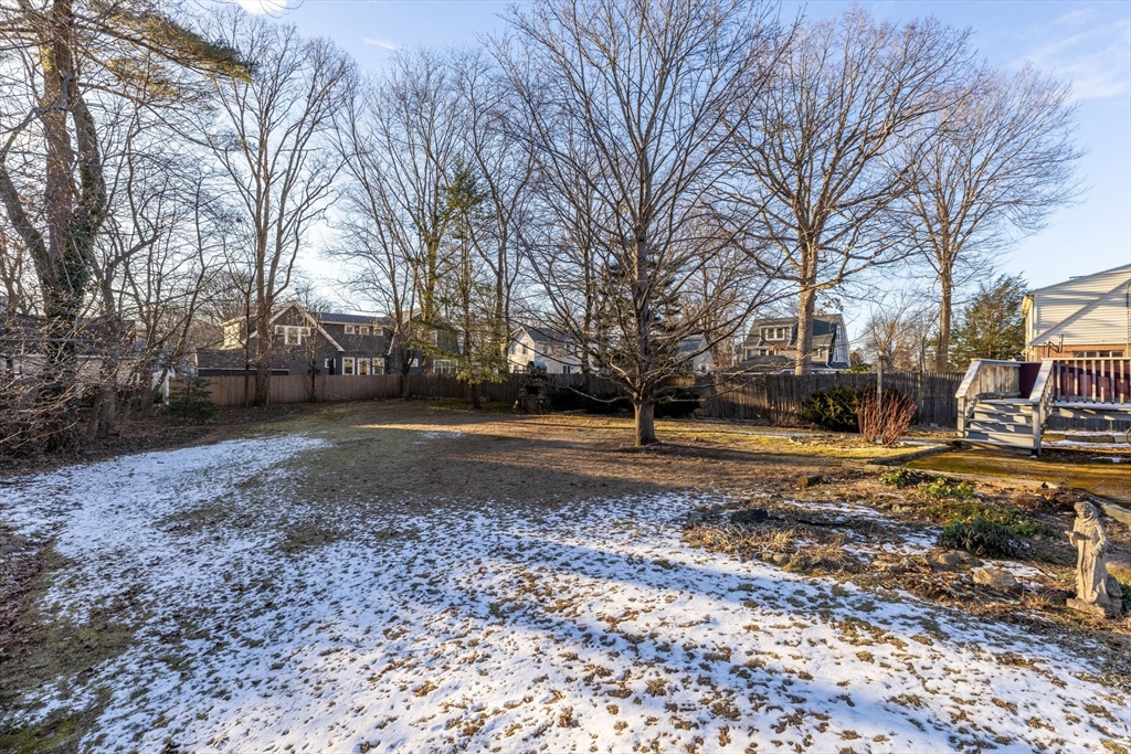 142 Bancroft Avenue Reading, MA 01867 - Photo 26 of 30 a view of a yard with a house and a large tree