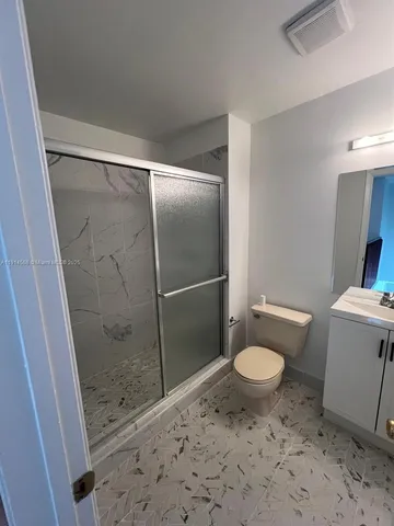 a bathroom with a sink toilet and shower