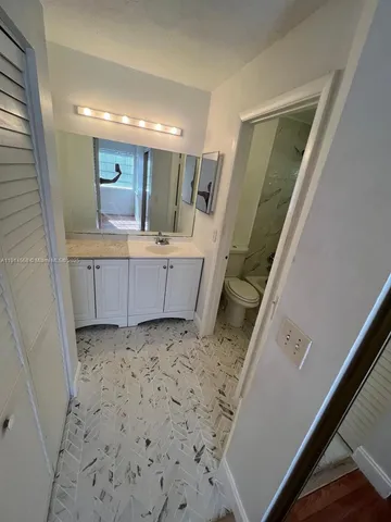 a bathroom with a sink a mirror and a vanity