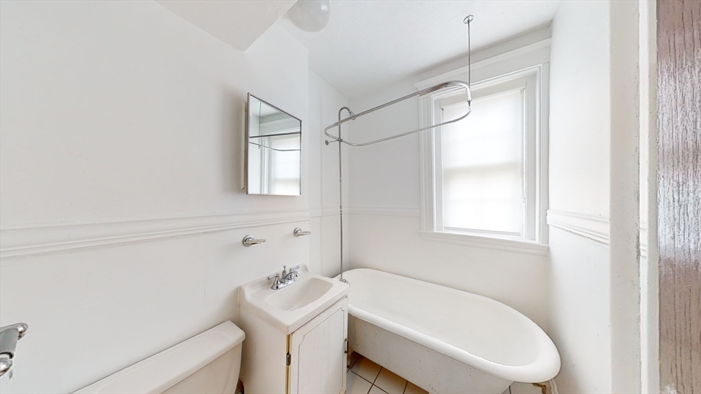 120 Summer Street, Unit 1 Malden, MA 02148 - Photo 10 of 14 a bathroom with a sink a toilet and shower