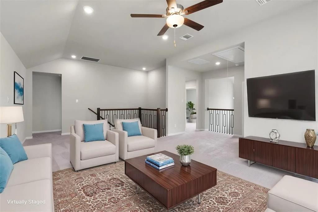 332 Stellar Wind Drive Georgetown, TX 78628 - Photo 7 of 29 A comfortable loft living space offers high ceilings and carpeted flooring, creating an inviting atmosphere.