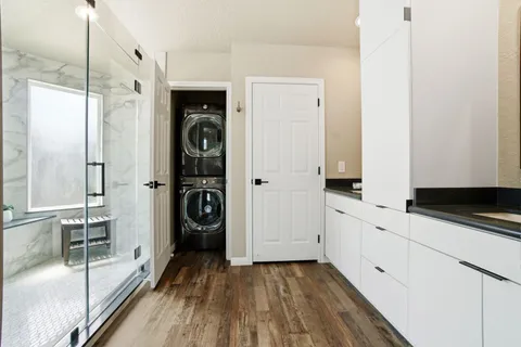 a kitchen with white cabinets and sink