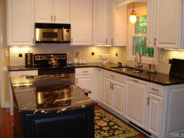 5501 North Hawthorne Way Raleigh, NC 27613 - Photo 3 of 10 a kitchen with stainless steel appliances granite countertop a stove a sink and a microwave