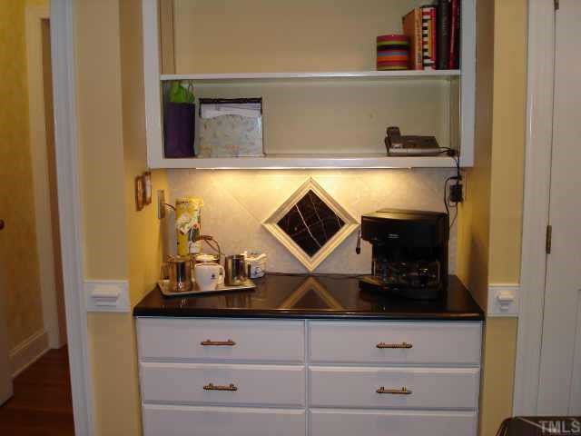 5501 North Hawthorne Way Raleigh, NC 27613 - Photo 4 of 10 a bathroom with a stove and cabinets