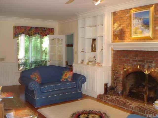 5501 North Hawthorne Way Raleigh, NC 27613 - Photo 5 of 10 a living room with furniture and a fireplace
