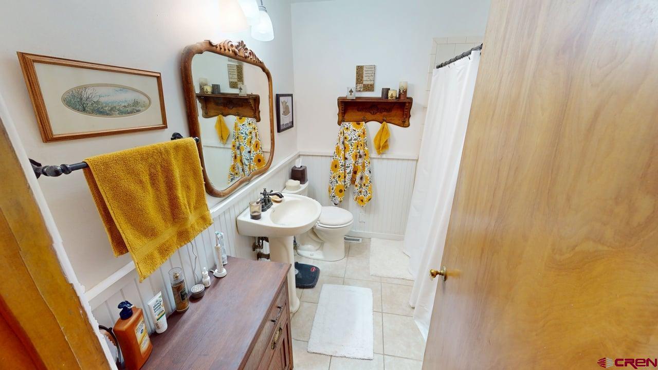 96 El Rio Drive Alamosa, CO 81101 - Photo 9 of 18 a bathroom with a sink toilet and mirror