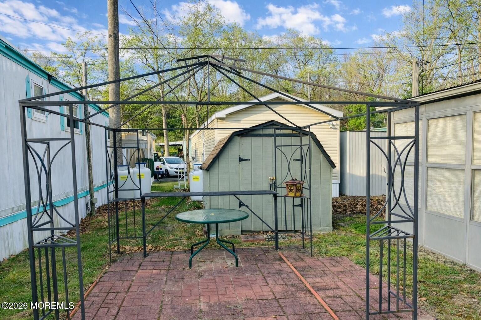 7 D Trail Brick, NJ 08724 - Photo 3 of 11 a backyard of a house with table and chairs