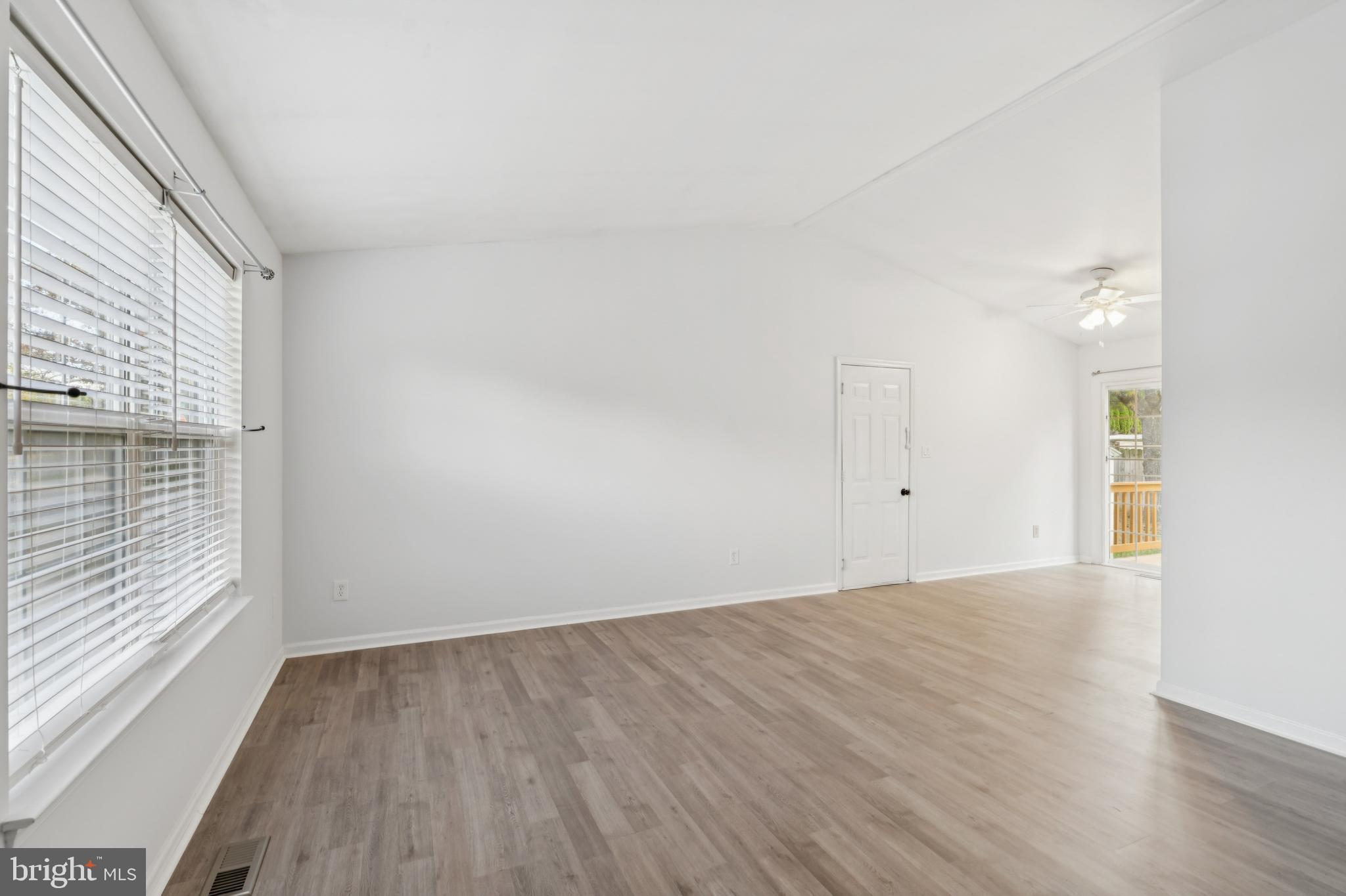 1151 Caton Road Hampstead, MD 21074 - Photo 15 of 43 a view of an empty room with wooden floor and a window