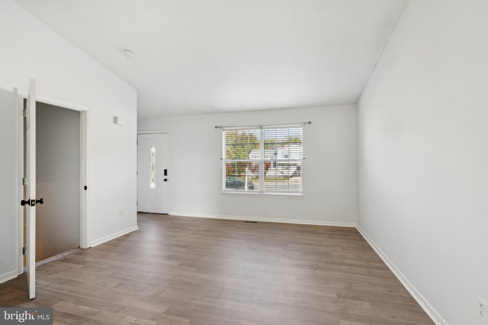 1151 Caton Road Hampstead, MD 21074 - Photo 17 of 43 an empty room with wooden floor and windows