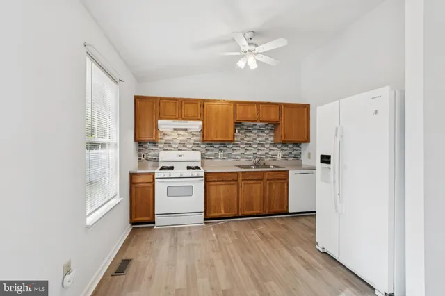 a kitchen with a refrigerator and stove