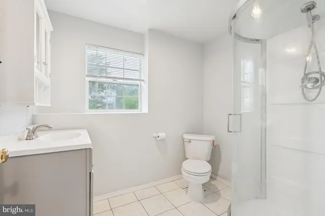 a bathroom with a sink a window and mirror