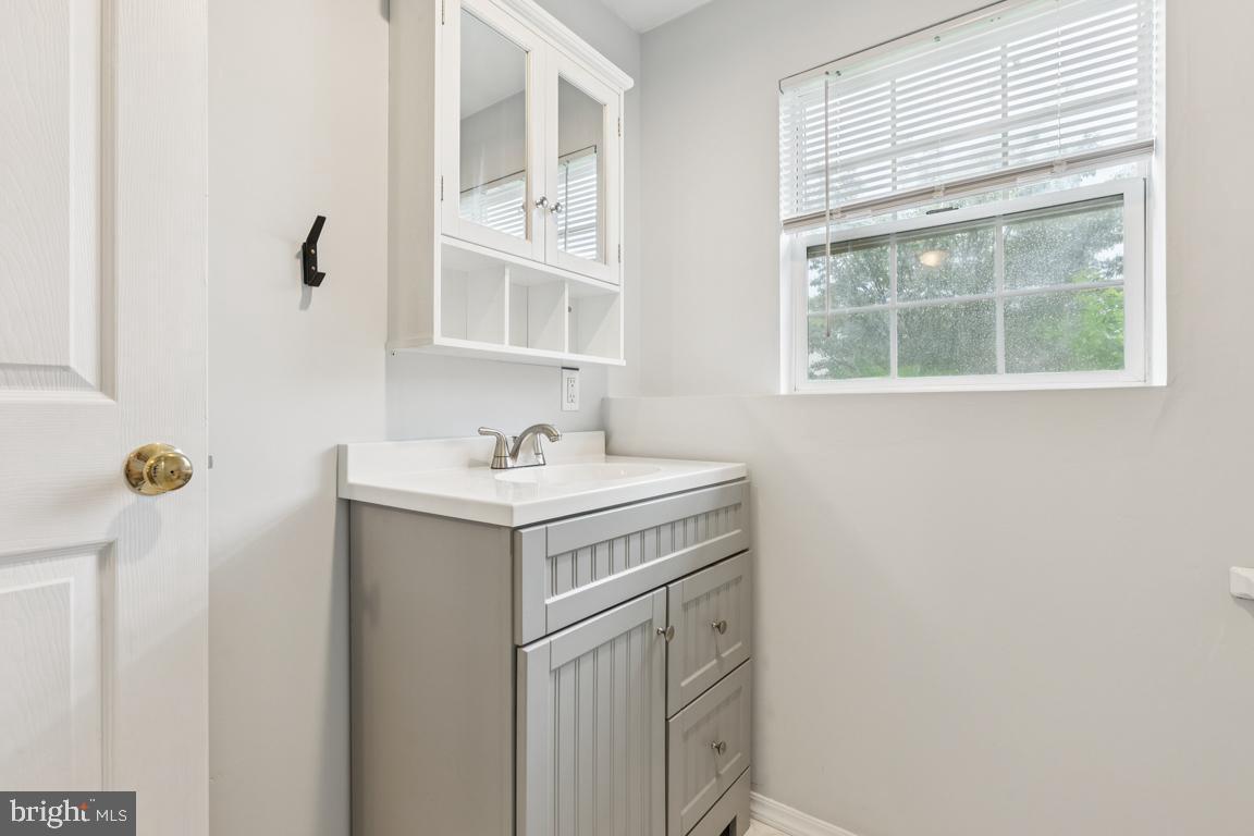 1151 Caton Road Hampstead, MD 21074 - Photo 26 of 43 a bathroom with a sink a window and mirror