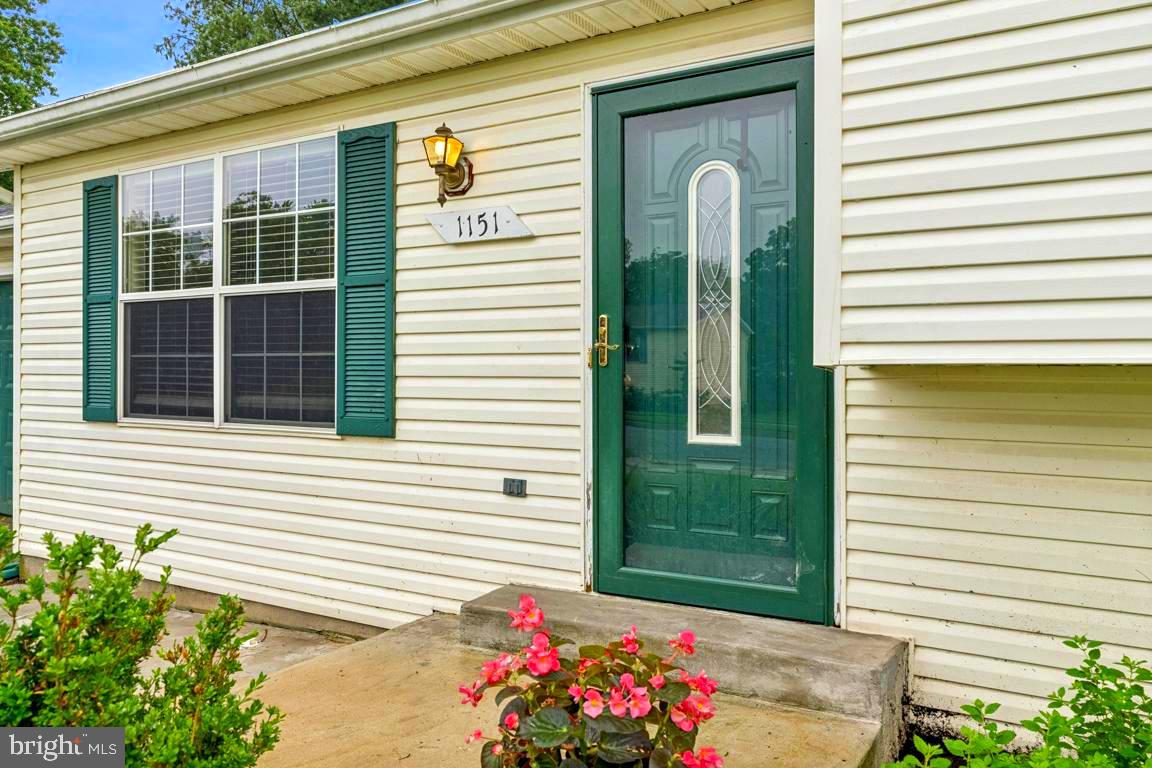 1151 Caton Road Hampstead, MD 21074 - Photo 6 of 43 a front view of a house with a garden