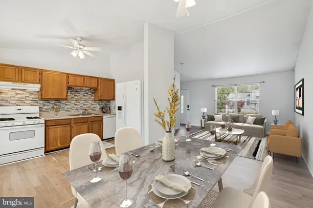 a living room with furniture a fireplace and kitchen view