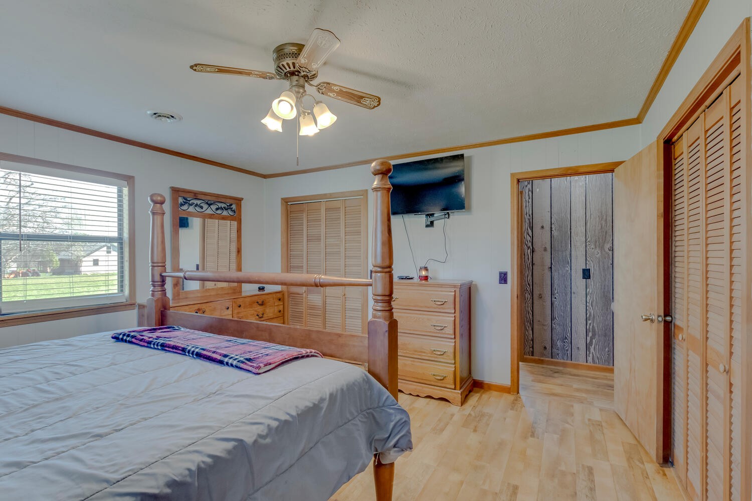 259 Toad Road Dowelltown, TN 37059 - Photo 11 of 19 a bedroom with a large bed and a chandelier