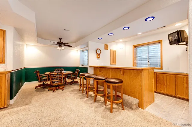 a view of a house with a yard and potted plants