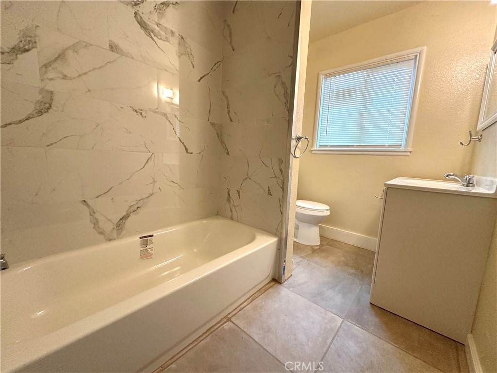 828 West 23rd Street Merced, CA 95340 - Photo 11 of 19 a bathroom with a sink a toilet and shower