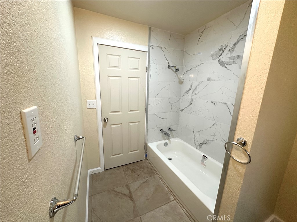 828 West 23rd Street Merced, CA 95340 - Photo 12 of 19 a bathroom with a granite countertop sink toilet and shower