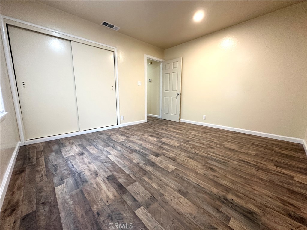 828 West 23rd Street Merced, CA 95340 - Photo 7 of 19 a view of room with wooden floor