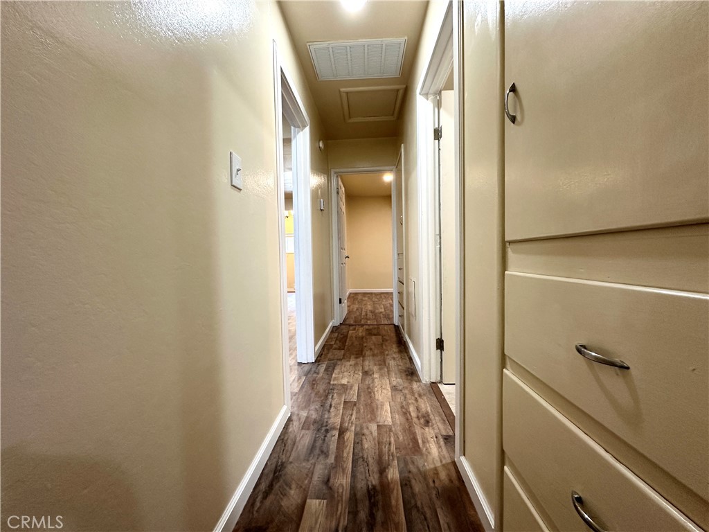 828 West 23rd Street Merced, CA 95340 - Photo 8 of 19 a view of a hallway with wooden floor and staircase